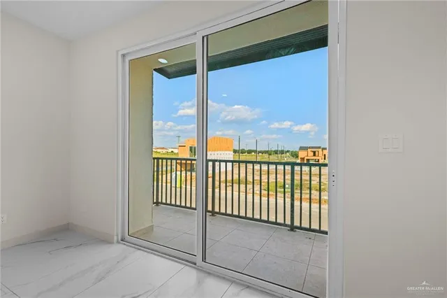 a view of a glass door with a balcony from a window