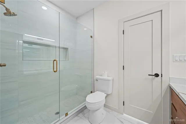 a bathroom with a toilet and a shower