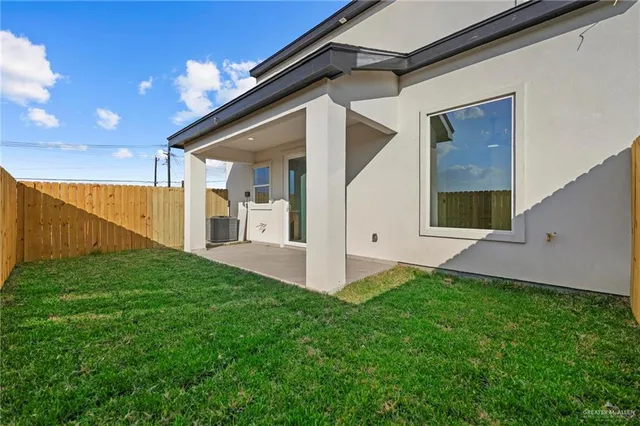 a view of an house with backyard and porch
