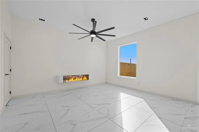 a view of a livingroom with a ceiling fan and window
