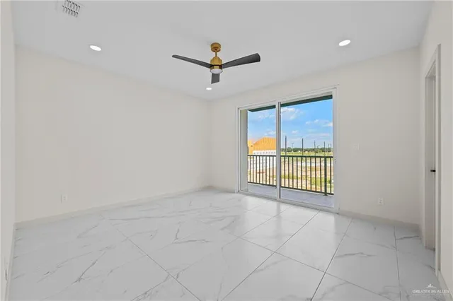 an empty room with windows and closet