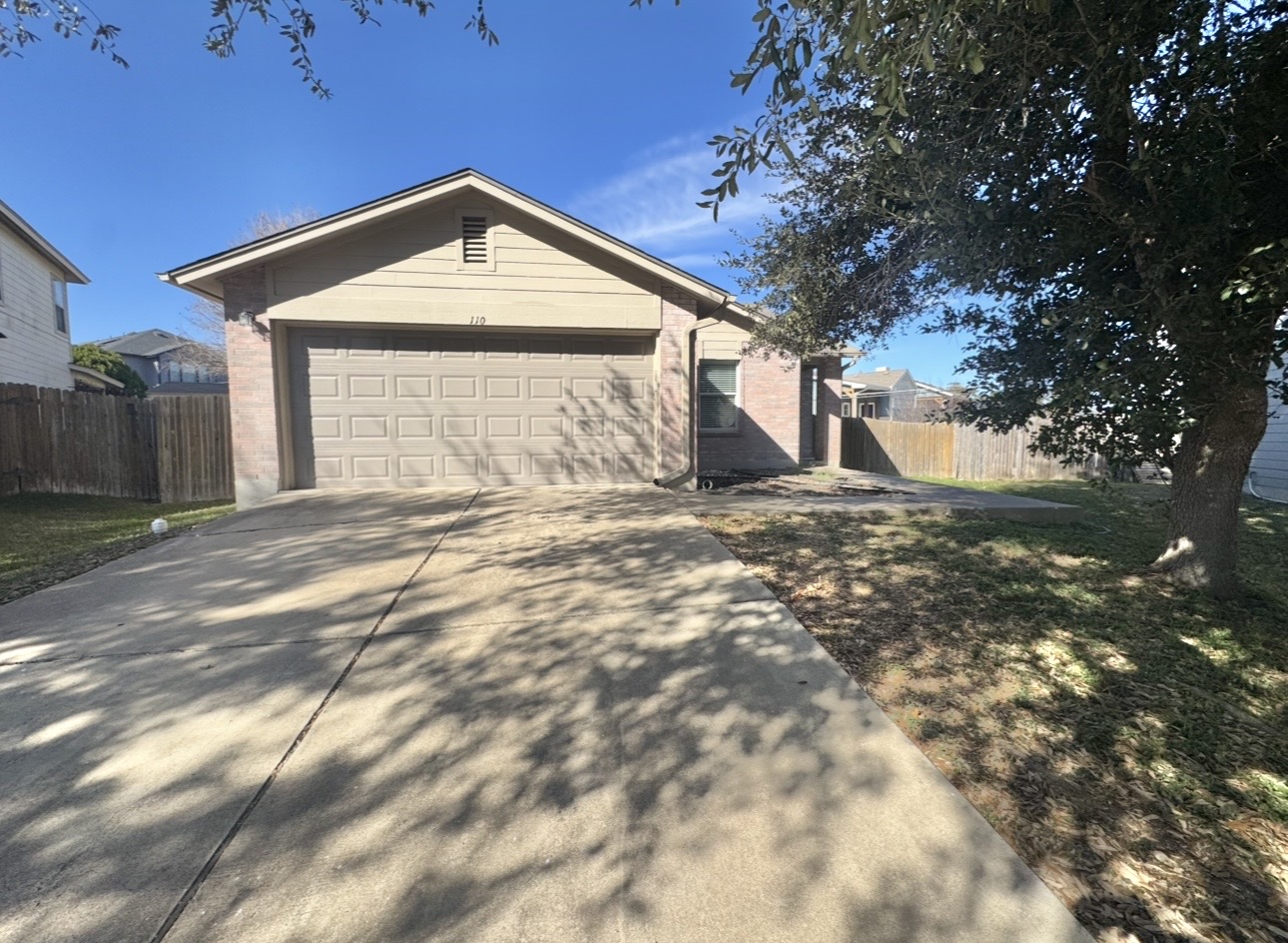 View of front of home featuring concrete driveway and an attached garage