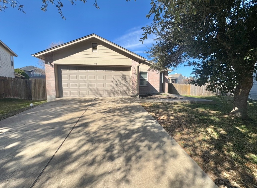 110 Comal Cove Elgin, TX 78621 - Photo 2 of 25 View of front of home featuring concrete driveway and an attached garage