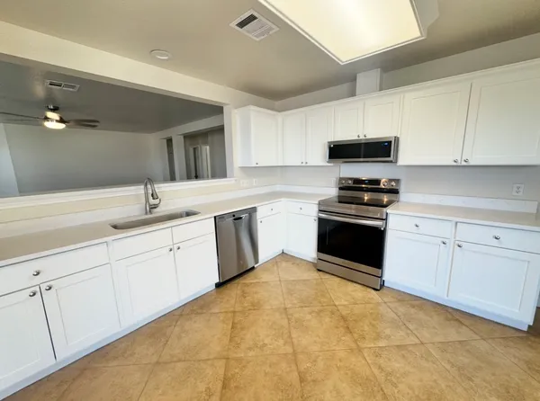 a kitchen with stainless steel appliances granite countertop a sink and cabinets