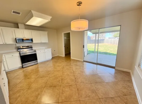 a kitchen with stainless steel appliances a refrigerator and a stove top oven
