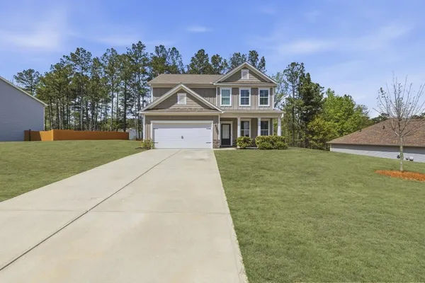 a front view of a house with a yard