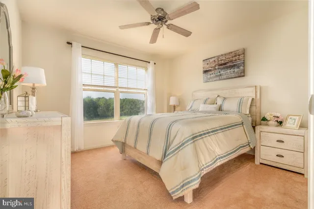 a spacious bedroom with a bed and a window