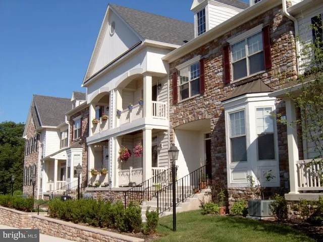 a front view of a residential apartment building with a yard
