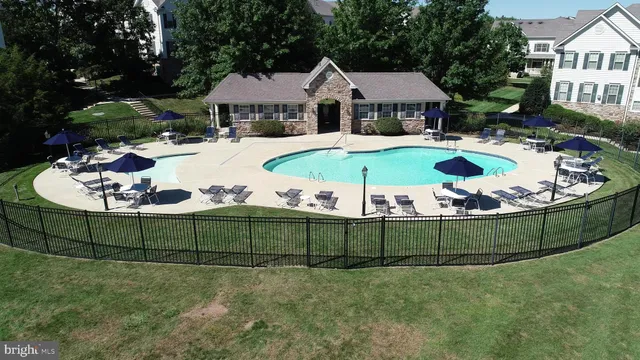 a view of a garden with a table and chairs under an umbrella