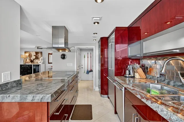 a kitchen with stainless steel appliances granite countertop a sink and a wooden cabinets