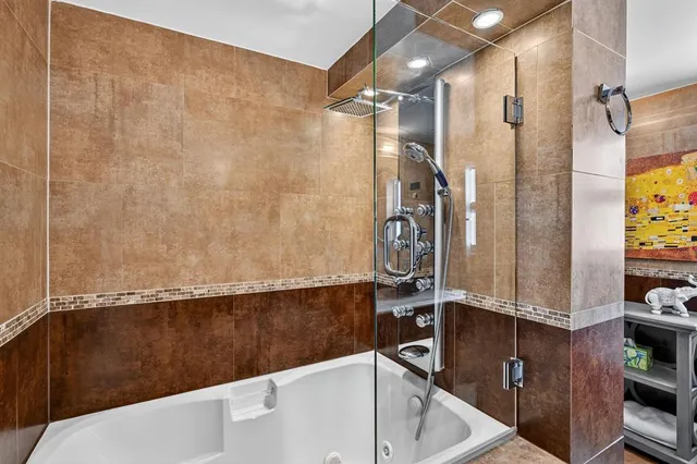 a bathroom with a bathtub and a shower