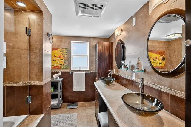 a bathroom with a bathtub and a shower