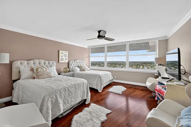 a large bedroom with a bed and large window