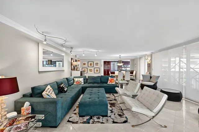 a living room with furniture fireplace and a large window