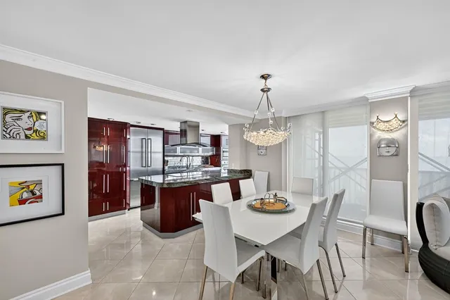 a large kitchen with a table and chairs
