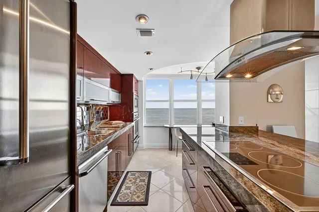 a kitchen with stainless steel appliances granite countertop a sink and wooden cabinets