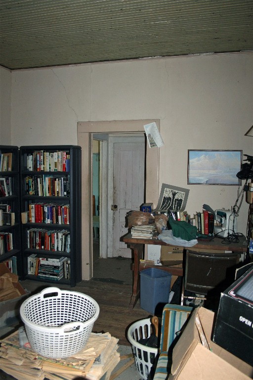 7887 Pettytown Road Red Rock, TX 78662 - Photo 13 of 26 a living room with furniture and a book shelf