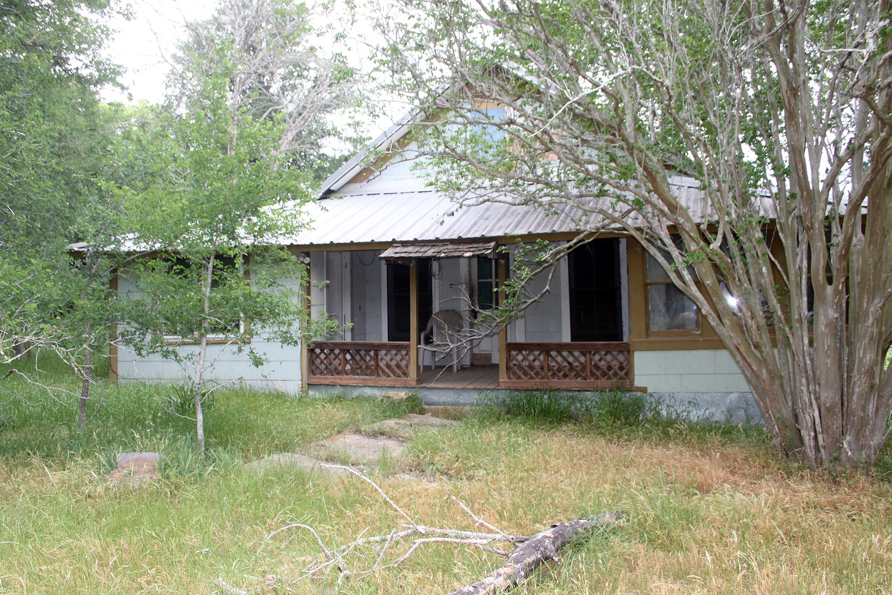 7887 Pettytown Road Red Rock, TX 78662 - Photo 14 of 26 a view of a house with backyard porch and sitting area