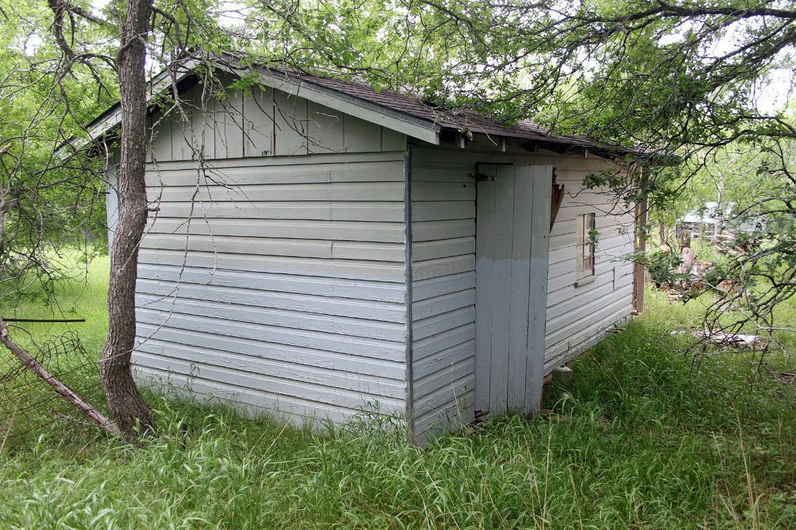 7887 Pettytown Road Red Rock, TX 78662 - Photo 16 of 26 a side view of a house with a yard