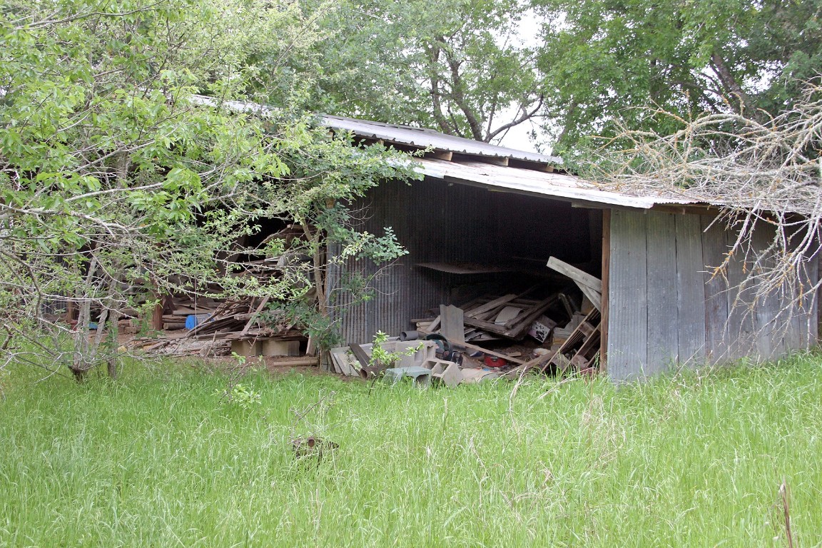 7887 Pettytown Road Red Rock, TX 78662 - Photo 21 of 26 a backyard of a house with table and chairs a barbeque
