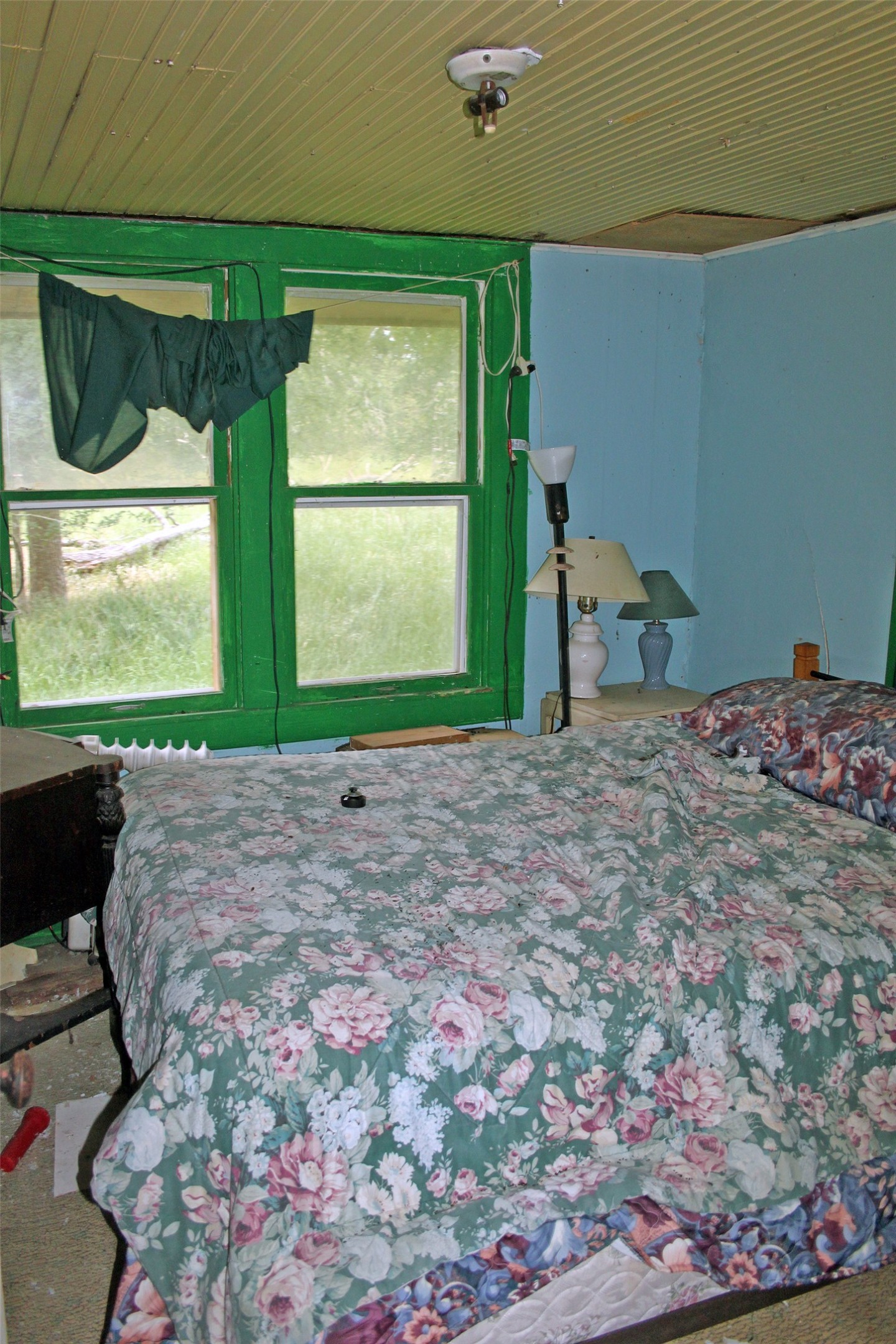 7887 Pettytown Road Red Rock, TX 78662 - Photo 6 of 26 a bed sitting in a bedroom next to a window