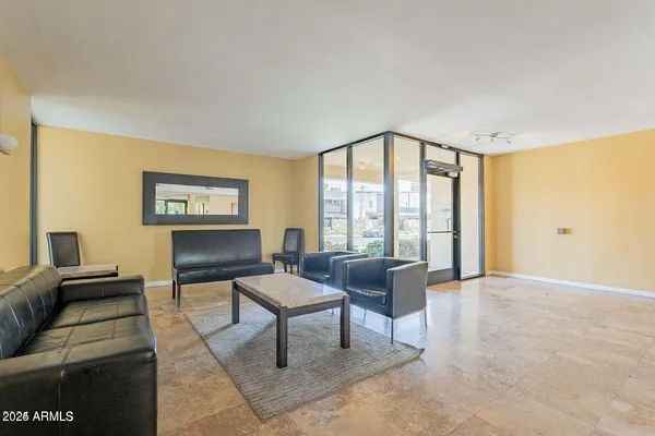 a living room with furniture and a floor to ceiling window