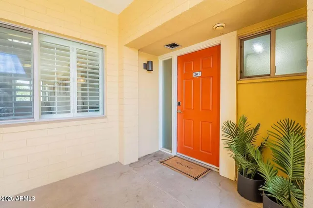 a view of a room with a window and a ceiling fan