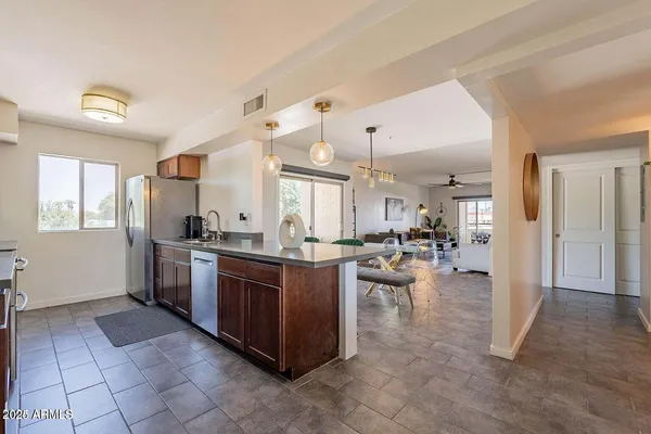 a kitchen with stainless steel appliances granite countertop a refrigerator and a sink