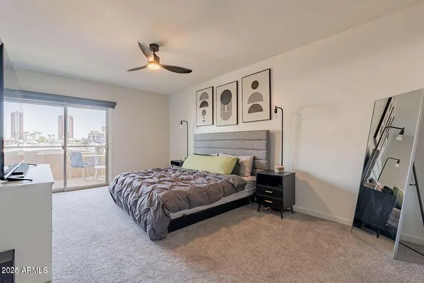 a bedroom with a bed and a ceiling fan