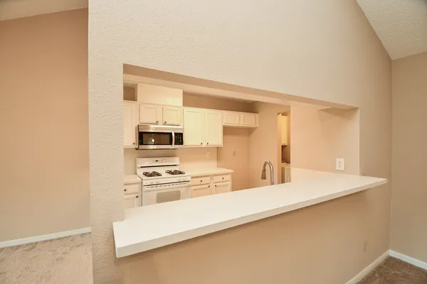 a kitchen with a sink stove and microwave
