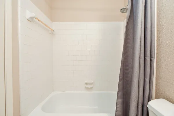 a bathroom with a sink a mirror a toilet and bathtub