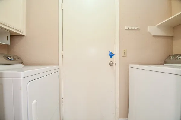 an empty room with a ceiling fan and window