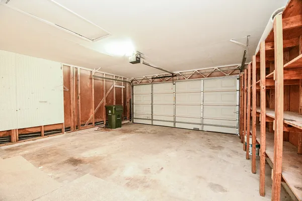 an empty room with a ceiling fan and window