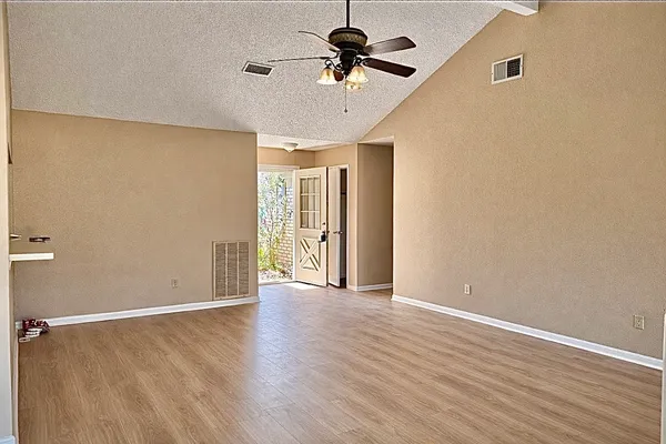 wooden floor in an empty room with a window