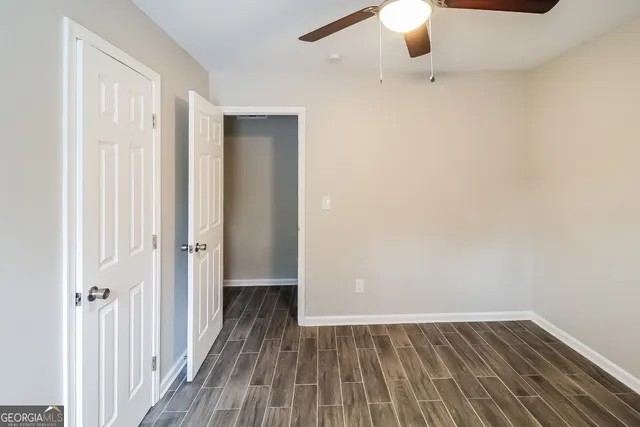 a view of a room with wooden floor staircase and a bathroom
