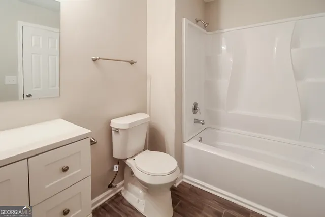 a bathroom with a toilet and a bathtub
