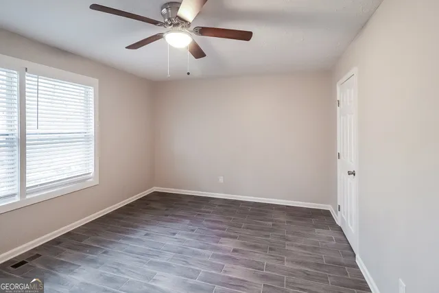 wooden floor in an empty room with a window