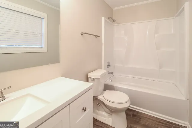 a bathroom with a sink a toilet and a bathtub