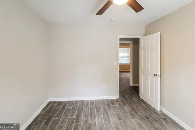 a view of an empty room with wooden floor