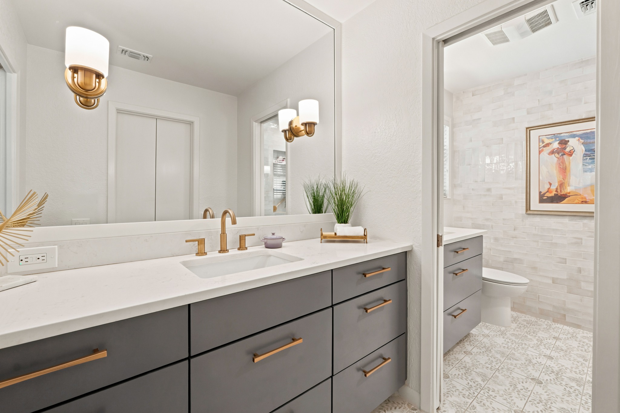 1904 Stoneridge Road Austin, TX 78746 - Photo 22 of 40 Renovated primary bath features a double vanity, modern cabinetry and updated finishes.