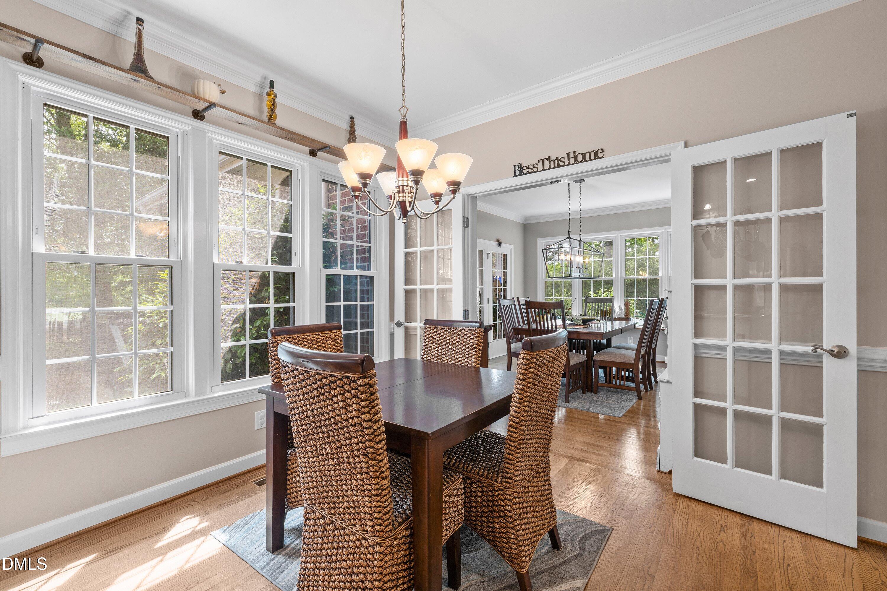 6612 Fowler Road Zebulon, NC 27597 - Photo 17 of 42 a dining room with furniture a chandelier and wooden floor