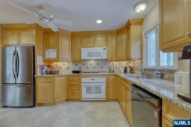230 Pinelynn Road Glen Rock, NJ 07452 - Photo 5 of 19 a kitchen with stainless steel appliances granite countertop a sink stove and refrigerator