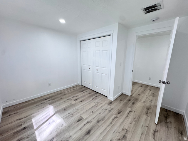 12339 Remy Road, Unit 422 Herriman, UT 84096 - Photo 33 of 36 Unfurnished bedroom featuring a closet, light wood-type flooring, and recessed lighting