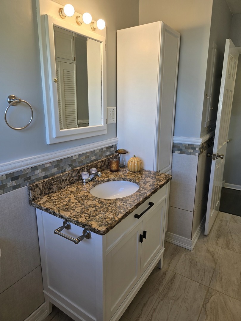 3618 148th Street Midlothian, IL 60445 - Photo 13 of 22 a bathroom with a granite countertop sink and a mirror