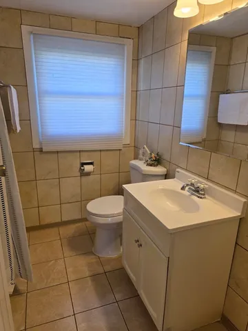 a bathroom with a sink toilet and mirror