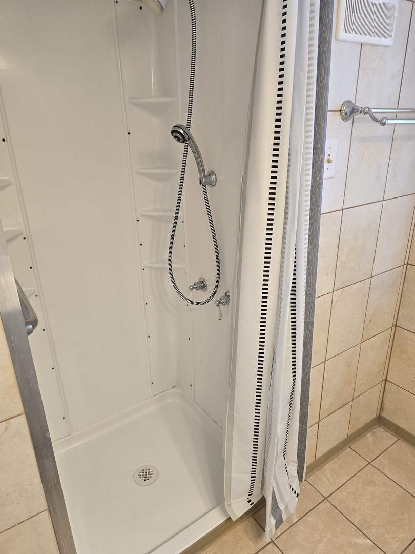 3618 148th Street Midlothian, IL 60445 - Photo 17 of 22 a bathroom with a glass shower door