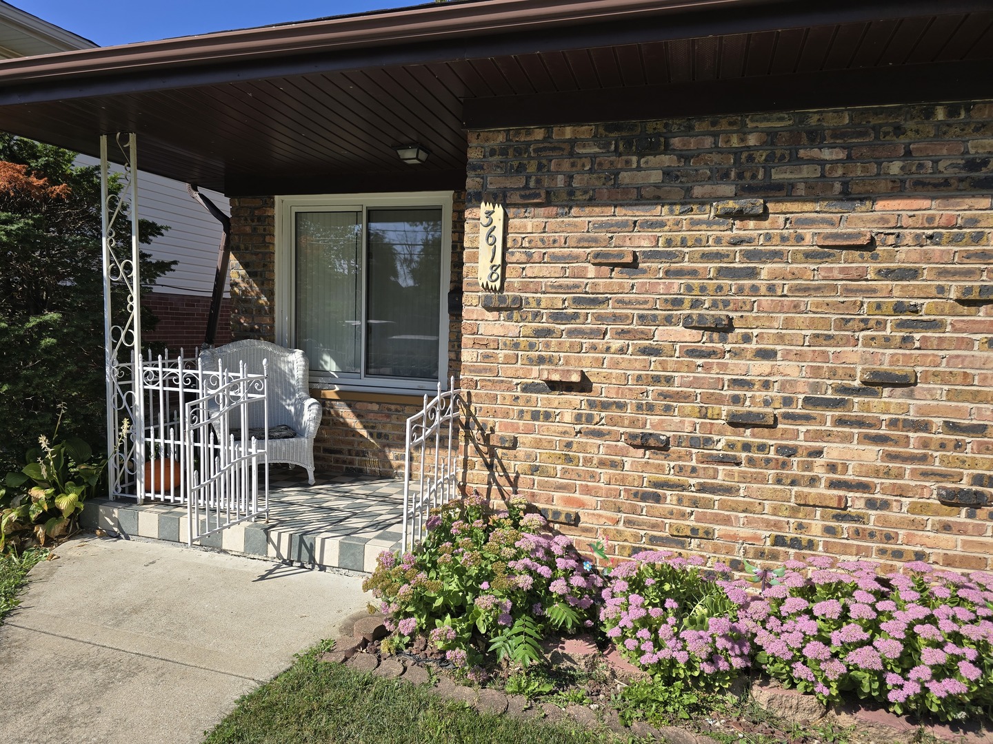 3618 148th Street Midlothian, IL 60445 - Photo 2 of 22 a building outdoor space with lots of flowers in it