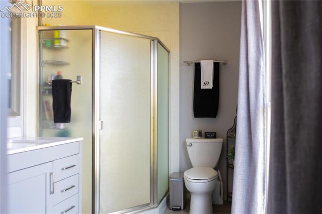 8115 Mustang Road Colorado Springs, CO 80908 - Photo 30 of 48 Full bath featuring vanity and a stall shower