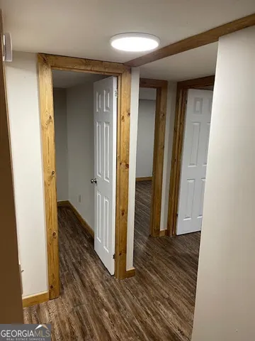 a view of a room with wooden floor