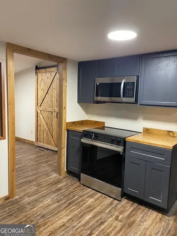 a kitchen with stainless steel appliances granite countertop a stove and a microwave